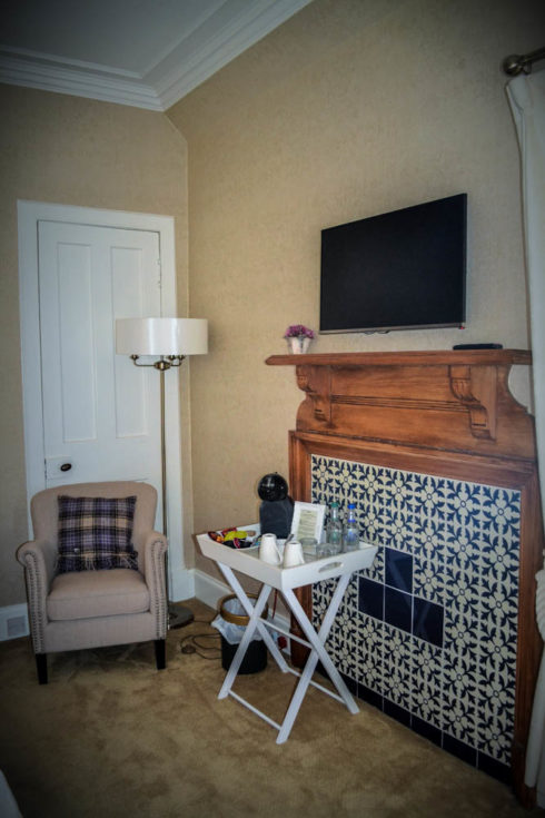 Inside view of Spey Room with vintage seat , lamp and side table
