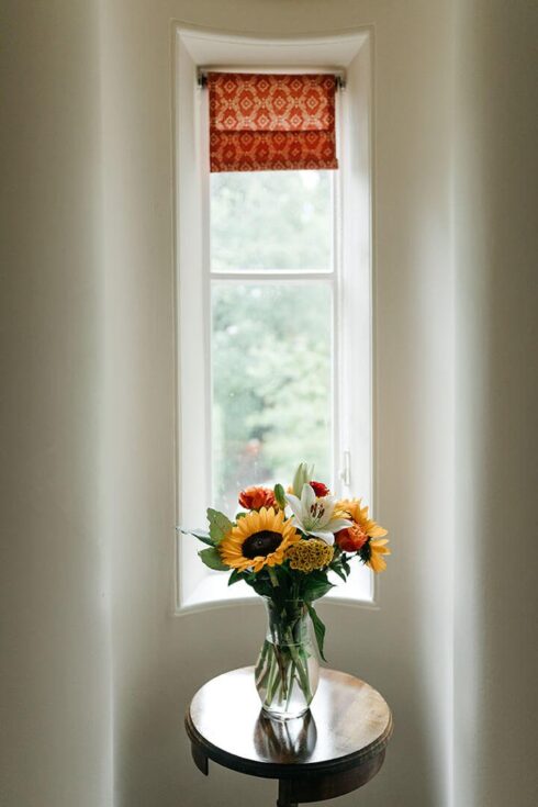 Bouquet on side table in front of window in Telford turret Room
